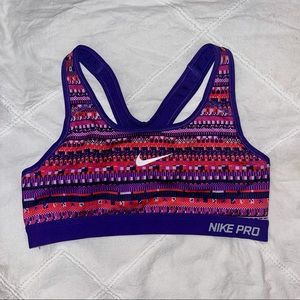 Women’s Nike Dri-Fit Sports Bra in pink and purple pixelated pattern.